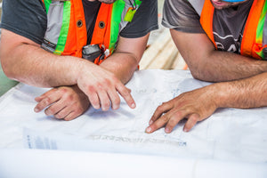 Two Construction Workers with Blueprint